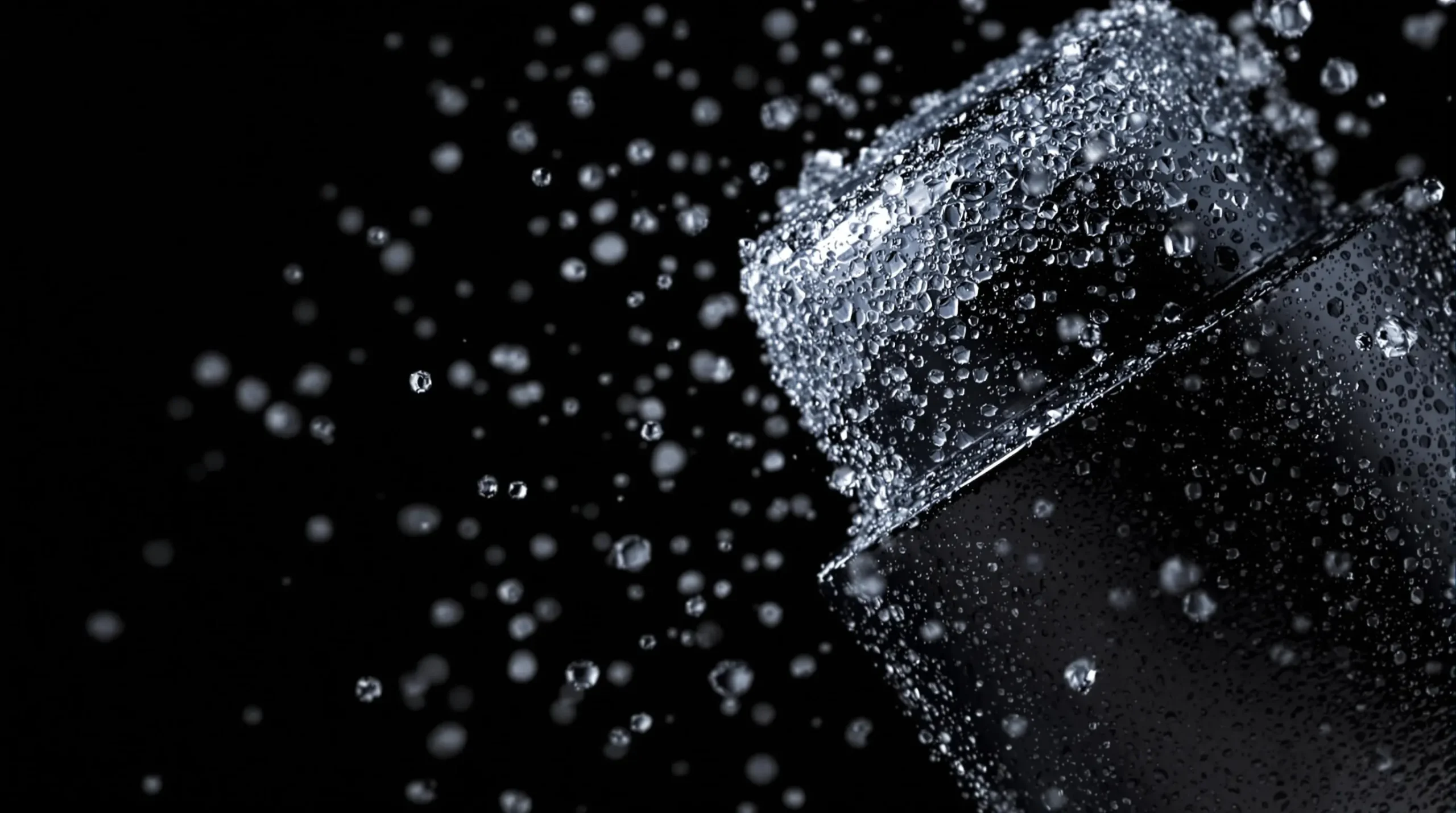 Frosty cocktail shaker in motion with ice crystals and condensation visible against dark background, capturing dynamic shaking action